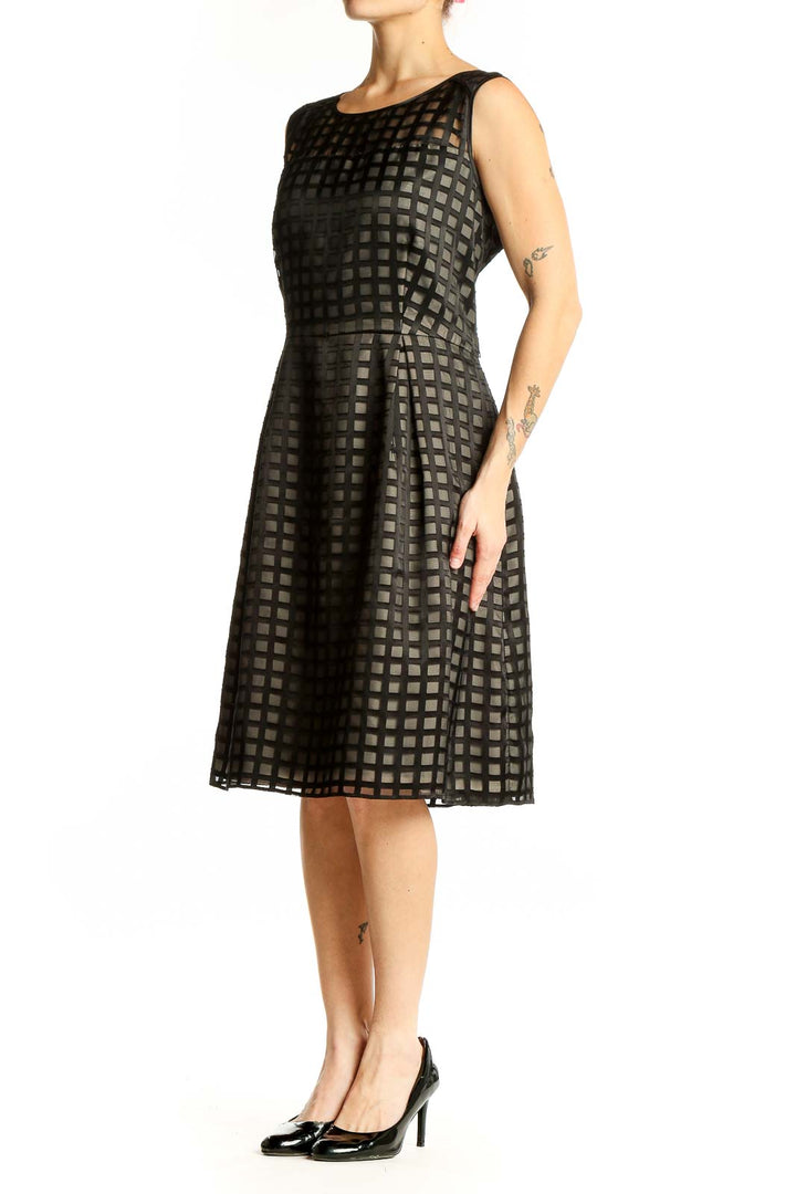 Front view of black Calvin Klein cocktail dress with grid pattern overlay