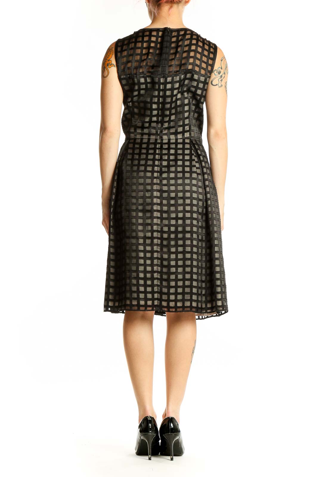 Side view of black Calvin Klein cocktail dress showing grid pattern and silhouette