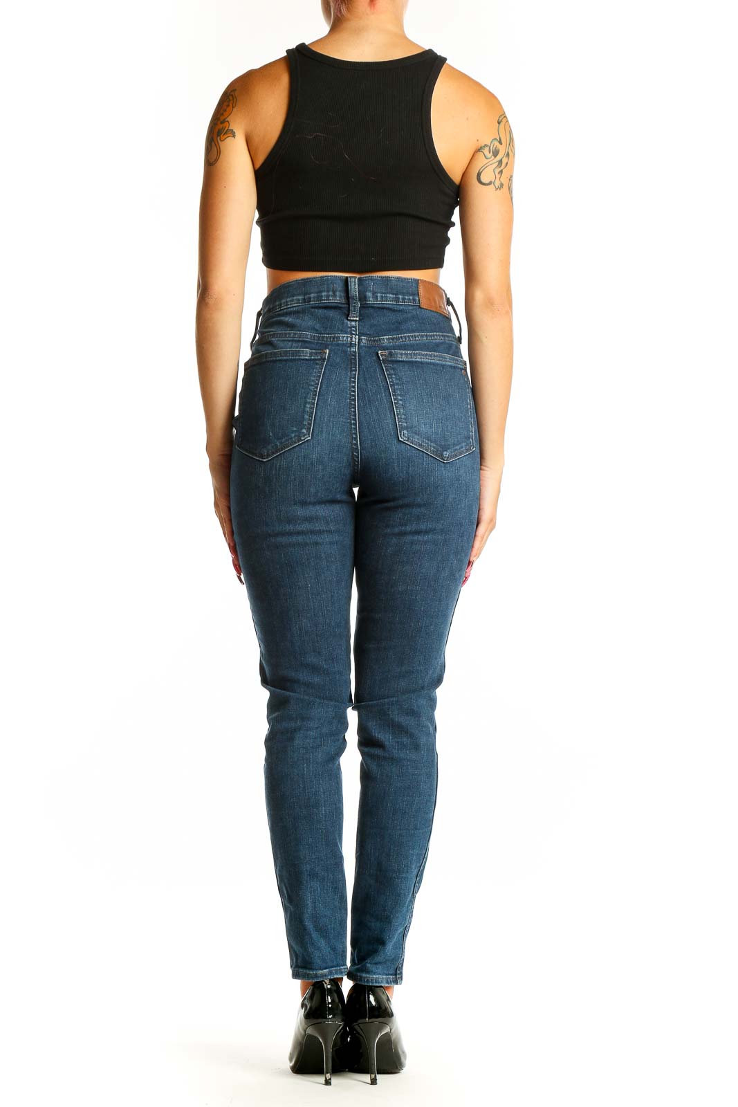Side view of woman wearing Madewell dark blue high-rise slim fit jeans