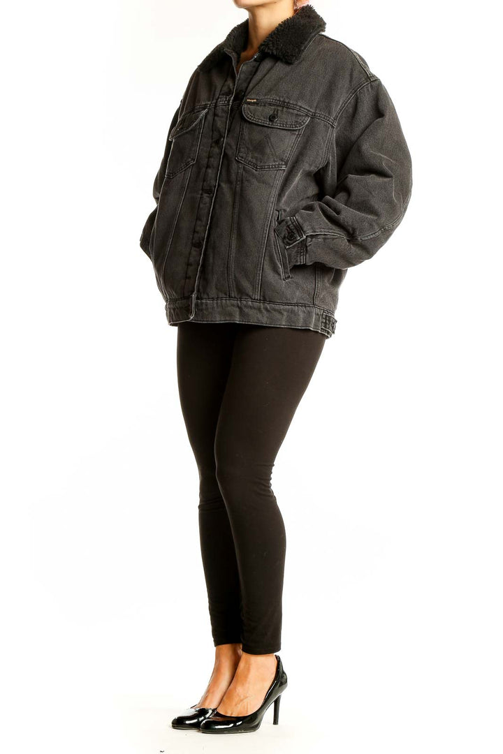 Front view of Wrangler black oversized denim jacket with faux fur collar