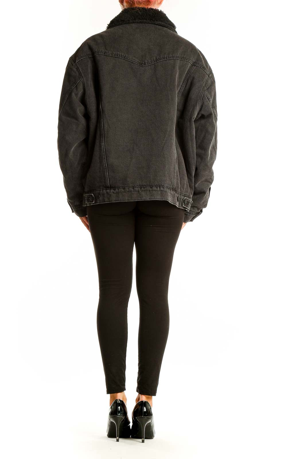 Side view of model wearing Wrangler black oversized denim jacket