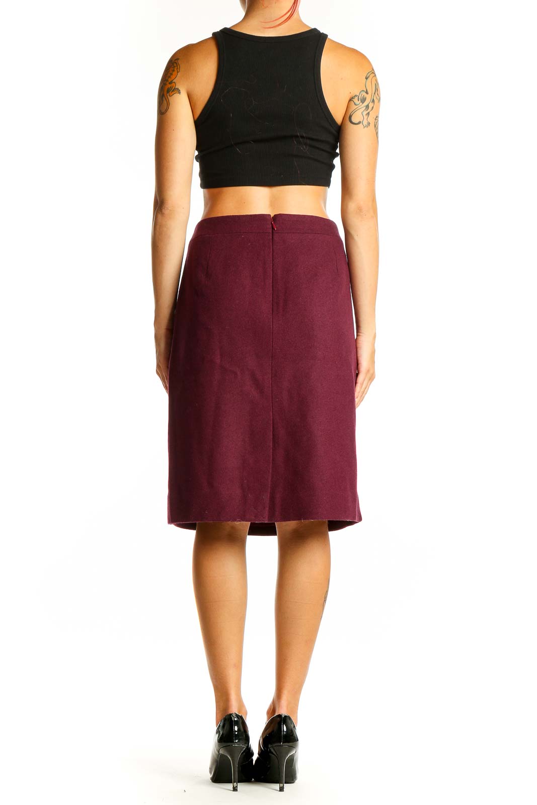 Side view of burgundy J.Crew pencil skirt on model with black top