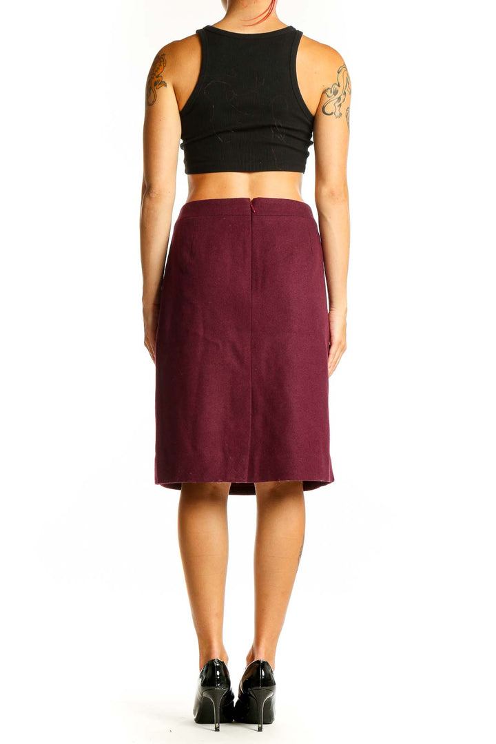 Side view of burgundy J.Crew pencil skirt on model with black top
