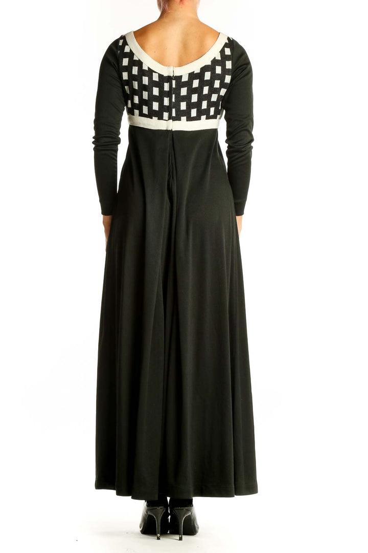 Back view of I.MAGNIN black maxi dress showing full-length silhouette and long sleeves