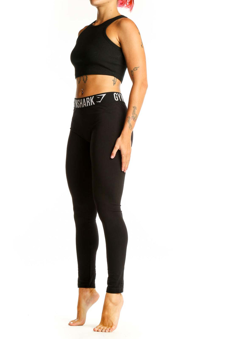 Front view of black Gymshark high-waisted leggings on female model