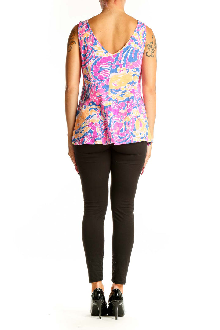 Side view of model wearing Lilly Pulitzer floral print cotton tank top with black pants
