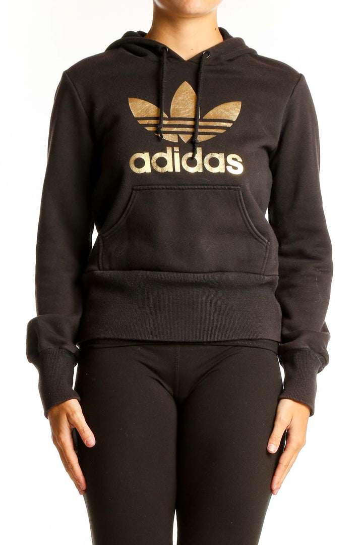 Front view of black Adidas hoodie with gold Trefoil logo