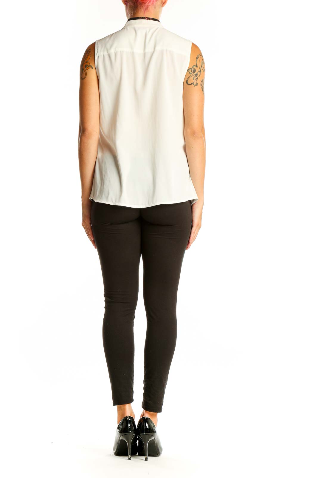 Side view of Calvin Klein white sleeveless blouse showing ruffle and fit