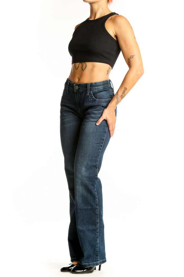 Front view of Wrangler dark blue bootcut jeans on model
