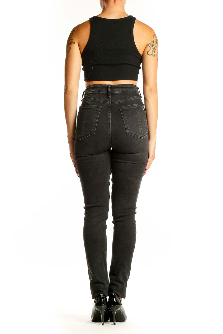 Side view of woman wearing Rag & Bone black high-waisted skinny jeans