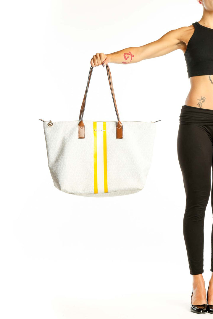 Front view of Michael Kors white tote bag with yellow stripes