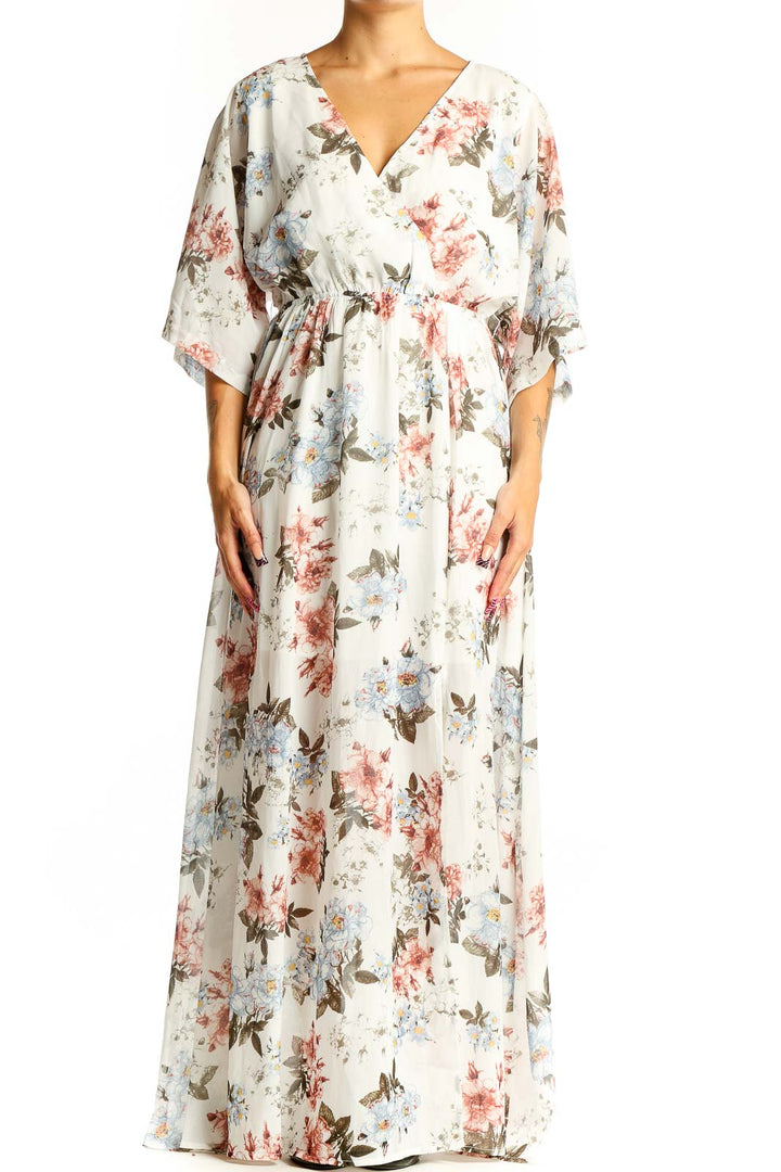 Front view of white floral maxi wrap dress with pink and blue flowers