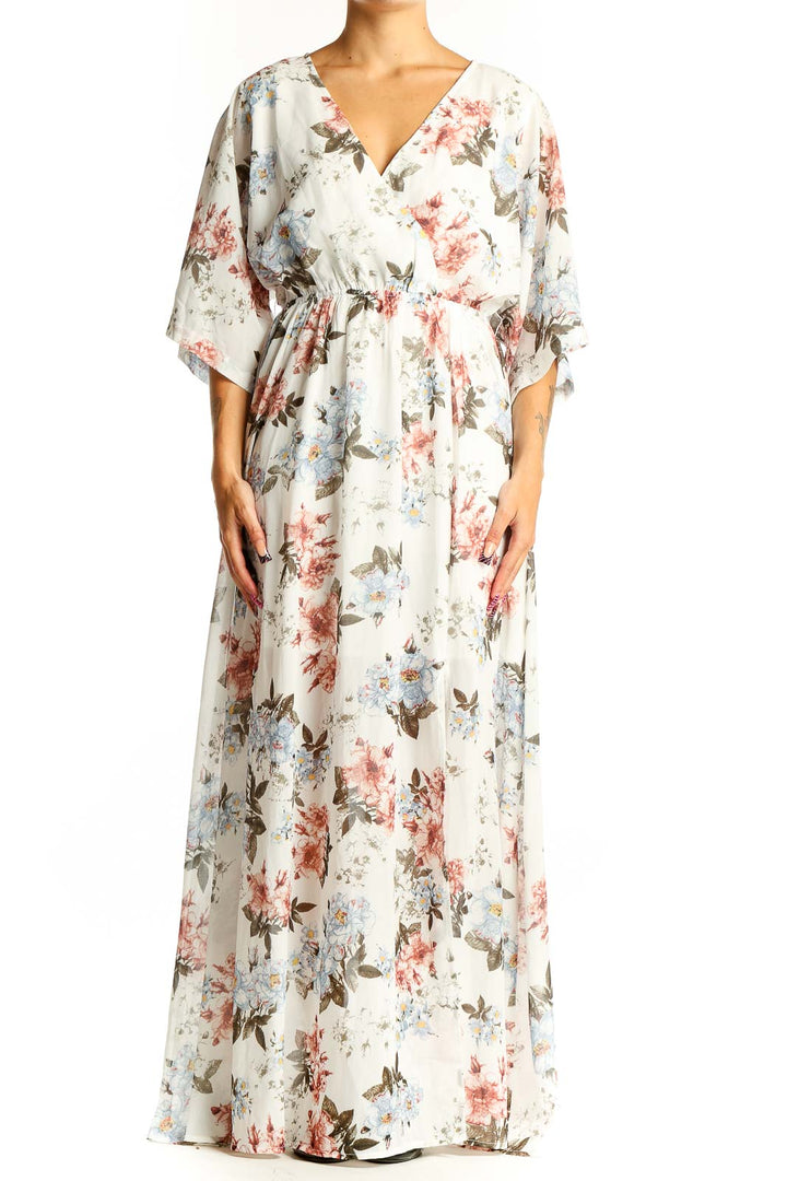 Front view of white floral maxi wrap dress with pink and blue flowers