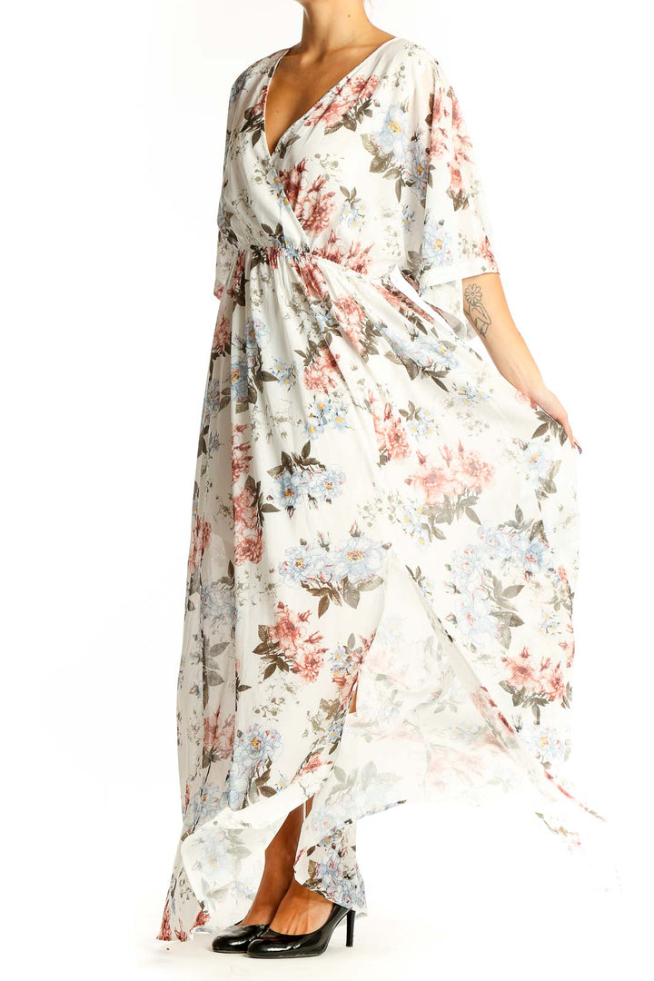 Front view of white floral maxi wrap dress with pink and blue flowers
