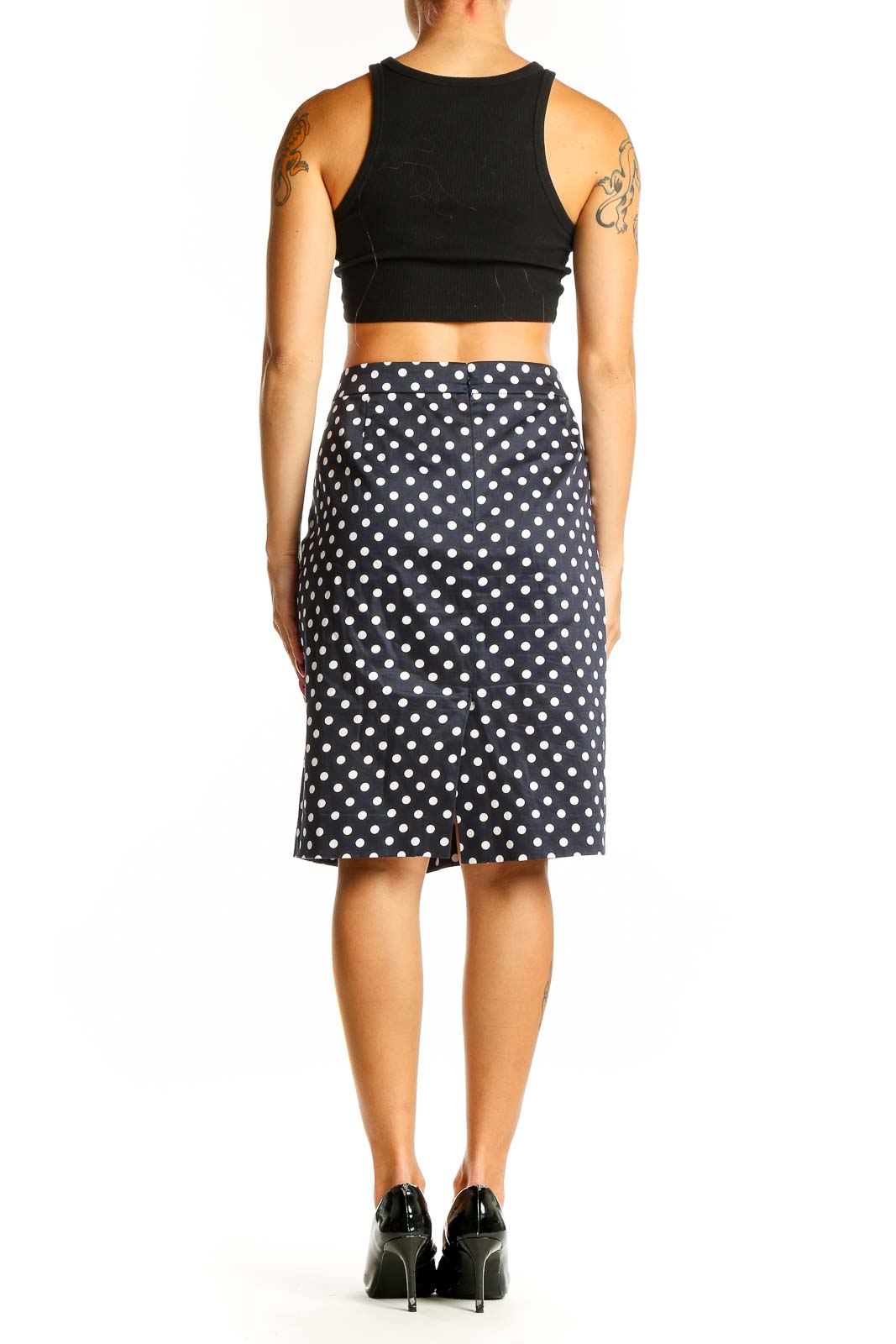 Side view of J.Crew navy polka dot pencil skirt with black crop top