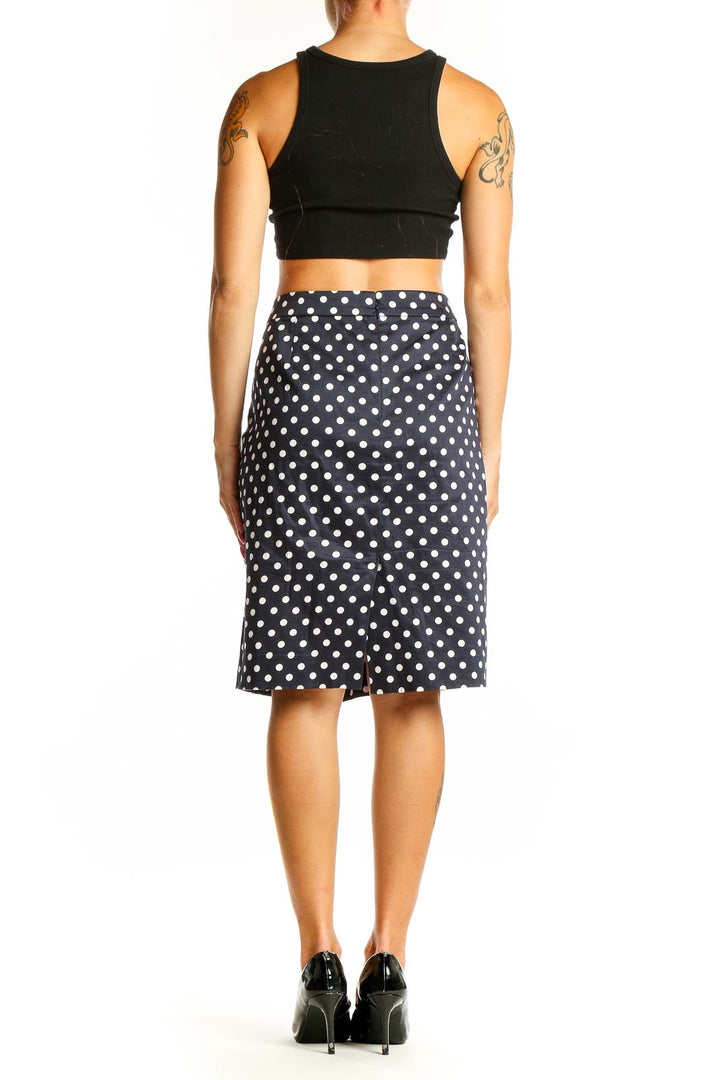 Side view of J.Crew navy polka dot pencil skirt with black crop top