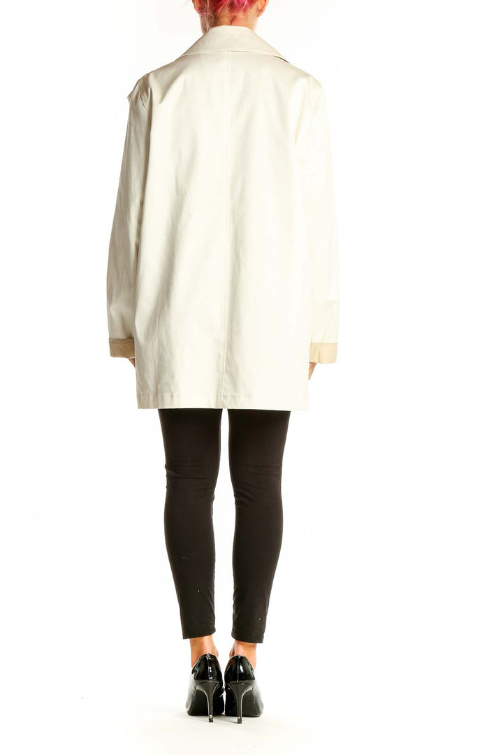 Side view of cream double-breasted coat by Weekend Max Mara on model