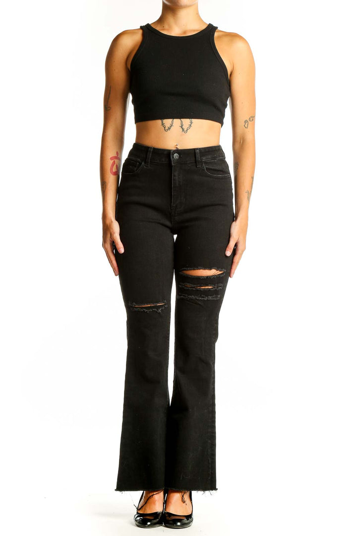 Front view of Guess black distressed flare jeans on model