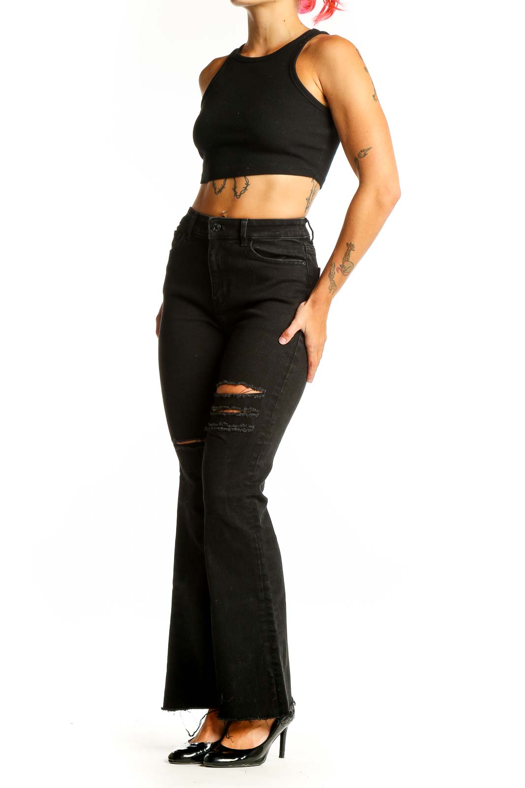 Front view of Guess black distressed flare jeans on model