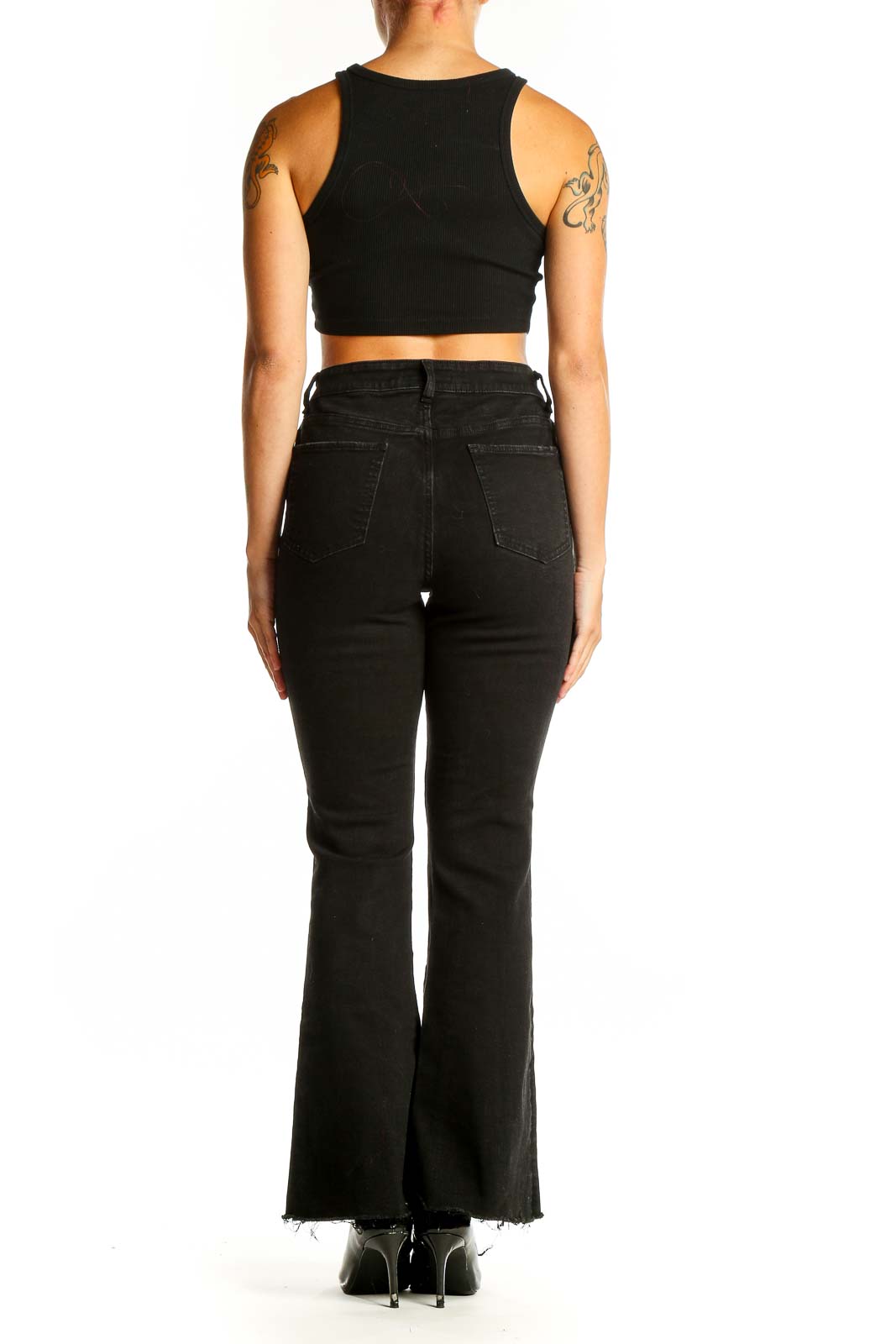 Side view of Guess black distressed flare jeans on model