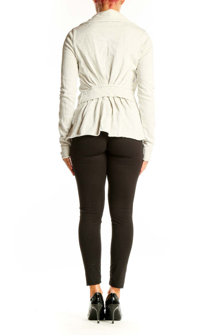 Side view of white ruffled cotton zip-up jacket from WE THE FREE on model