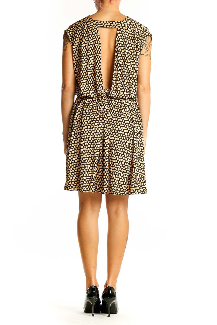Side view of Banana Republic brown polka dot sleeveless dress showing elastic waist