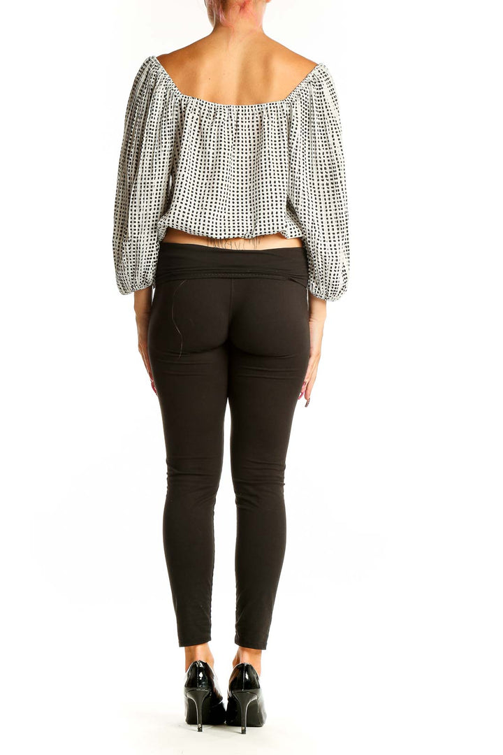 Side view of Lucy Paris White Polka Dot Crop Top paired with black pants
