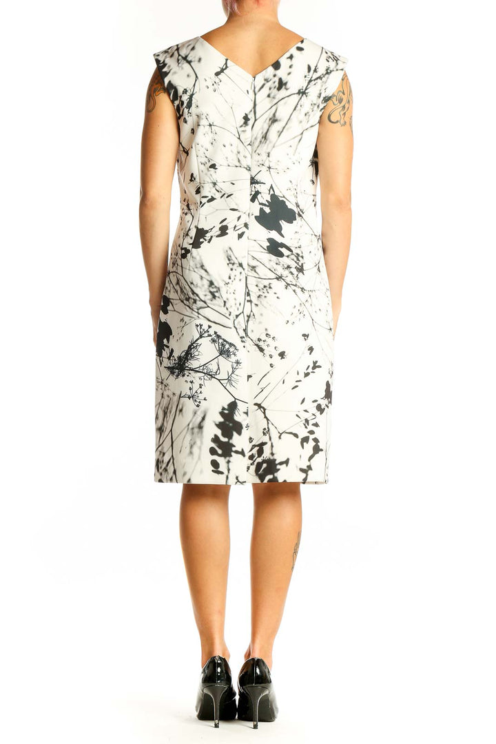 Side view of Tahari Arthur S. Levine white sheath dress showing sleeveless design and knee-length cut
