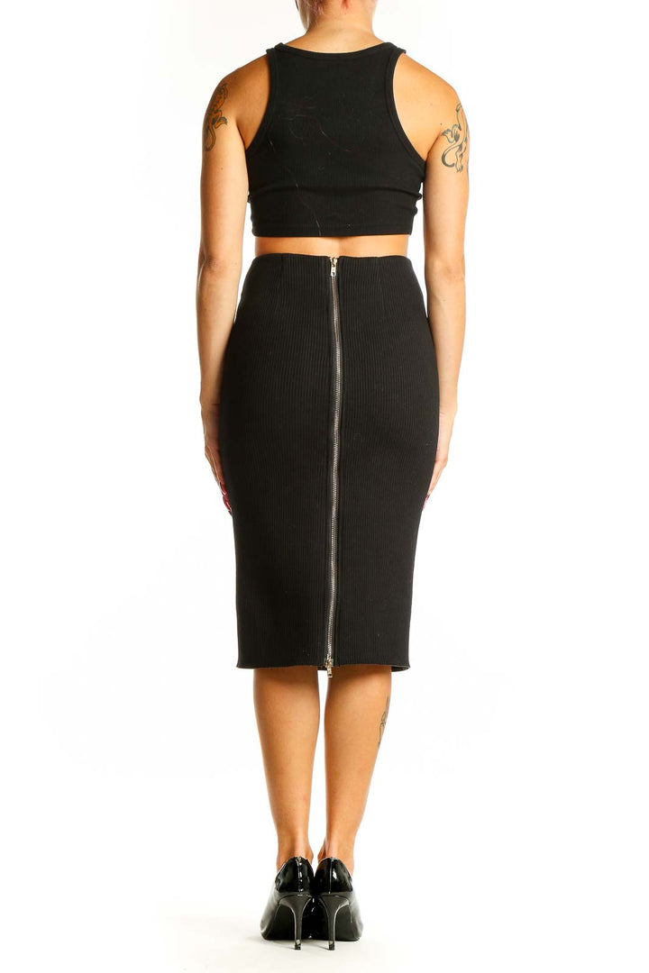 Side view of woman wearing black fitted midi pencil skirt by Six Crisp Days