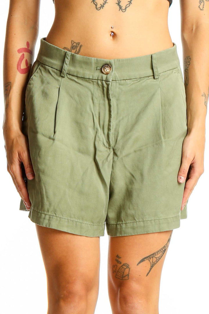 Front view of sage green LOFT pleated shorts