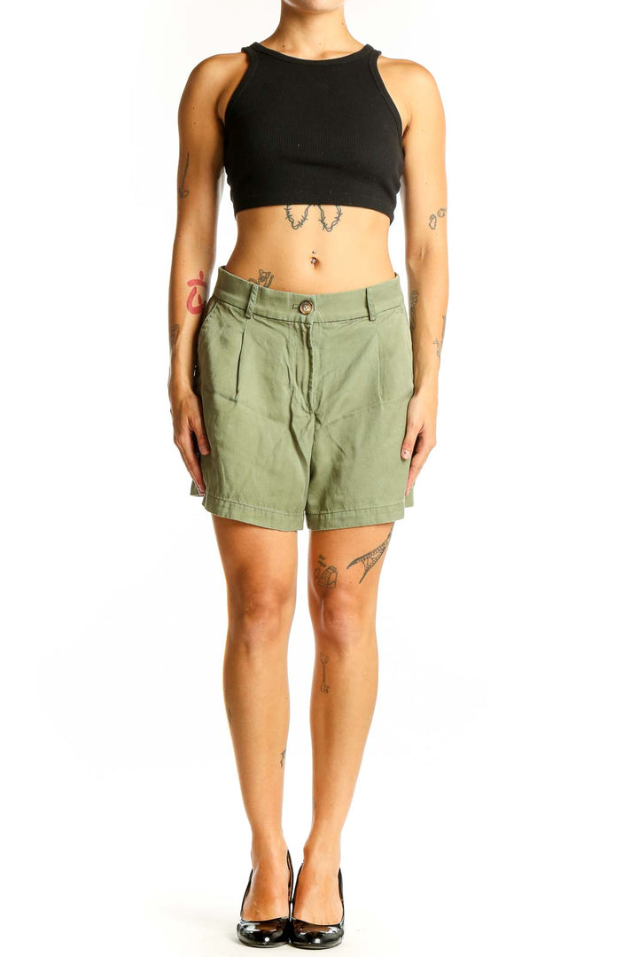 Front view of sage green LOFT pleated shorts