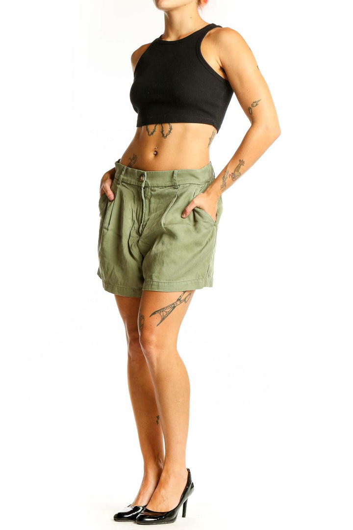 Front view of sage green LOFT pleated shorts
