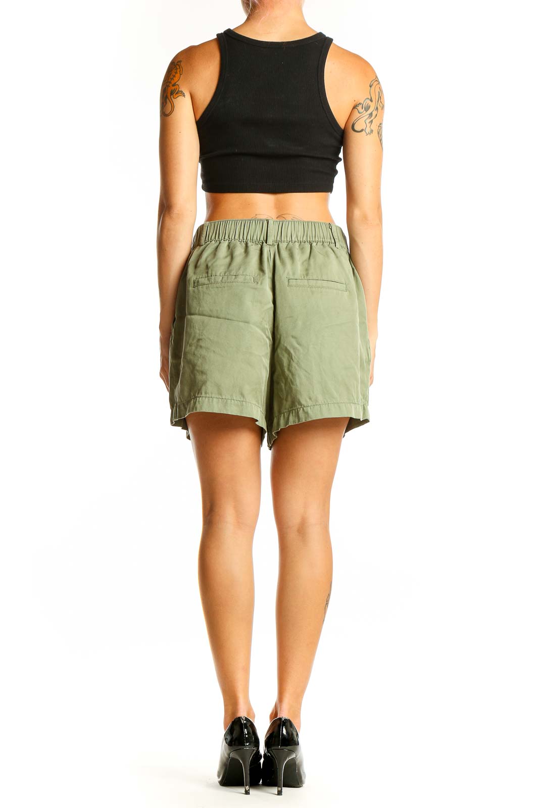 Side view of sage green LOFT shorts with black top