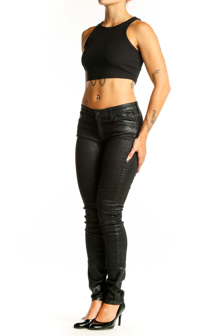 Front view of Adriano Goldschmied black coated skinny jeans on model