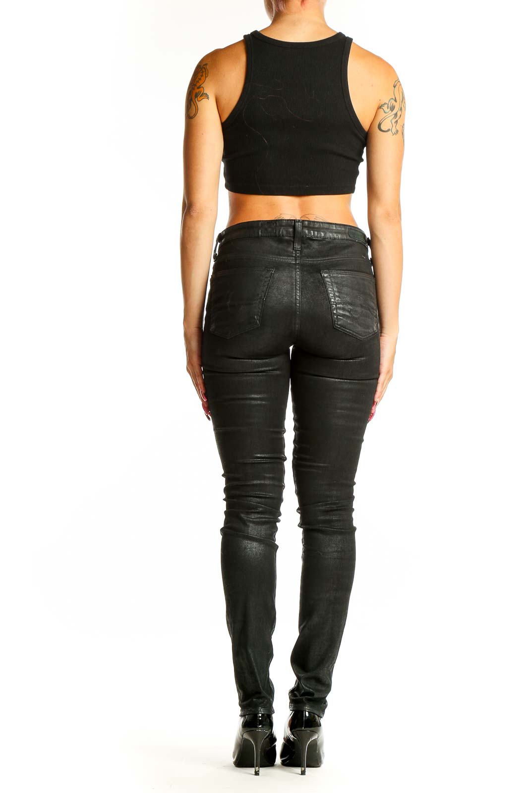 Side view of Adriano Goldschmied black coated skinny jeans on model with crop top