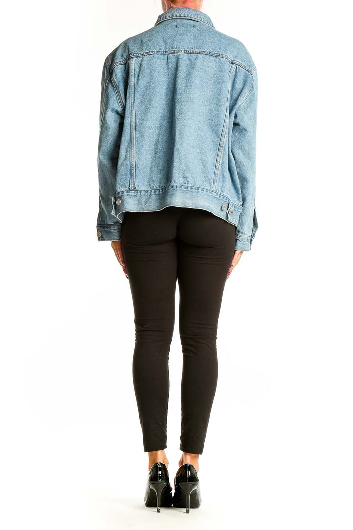 Back view of light blue oversized denim jacket on model