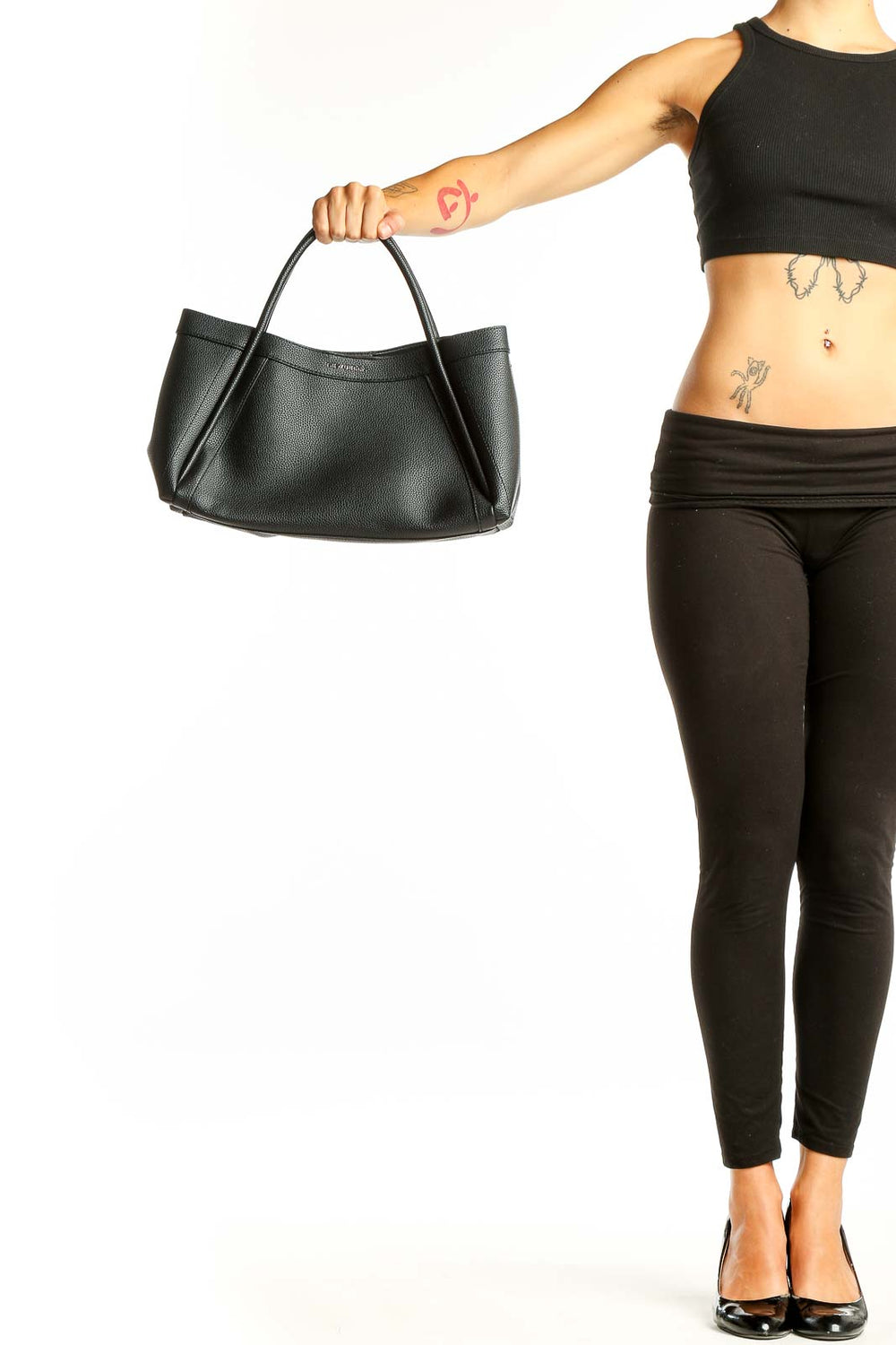 Black leather shoulder bag from NEWBELLA held by model's hand