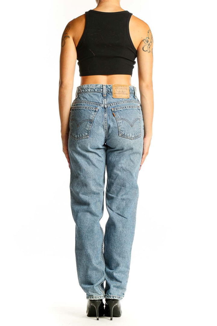 Side view of Levi's light blue straight leg jeans on model