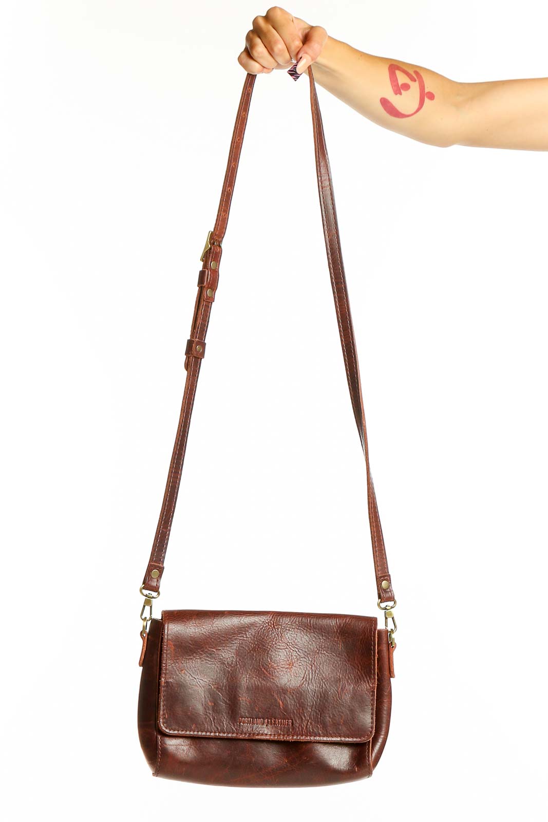 Front view of brown leather crossbody bag from A Portland leather goods