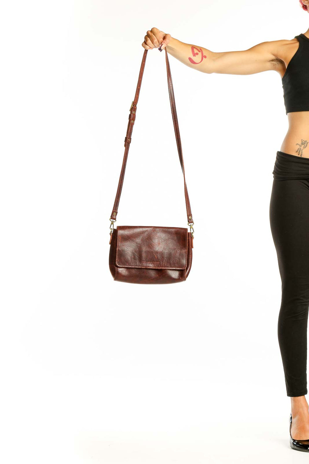 Front view of brown leather crossbody bag from A Portland leather goods