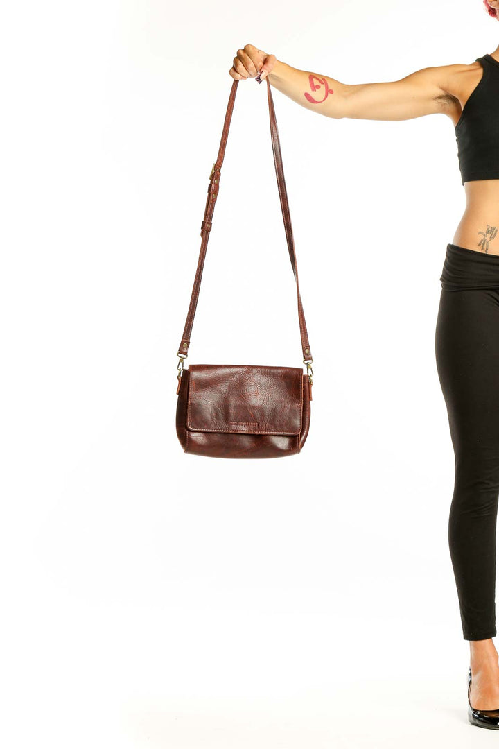 Front view of brown leather crossbody bag from A Portland leather goods