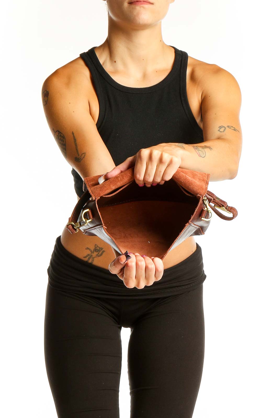 Side view of brown leather crossbody bag worn by model