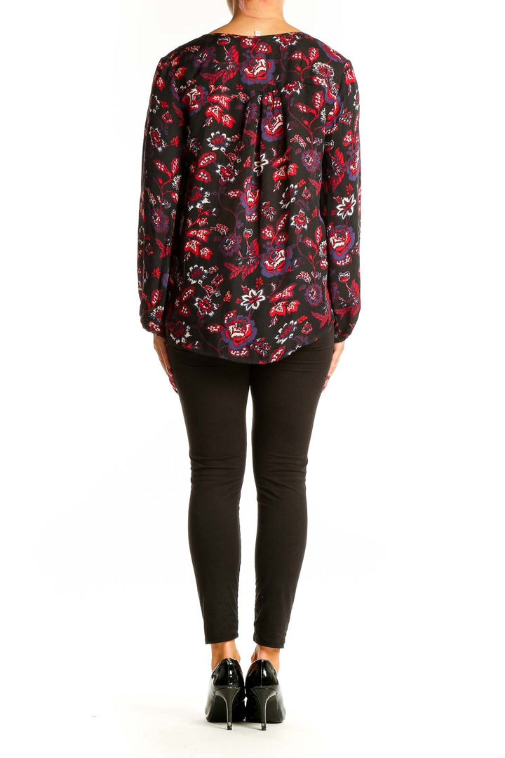 Back view of Joie black floral print silk blouse on model