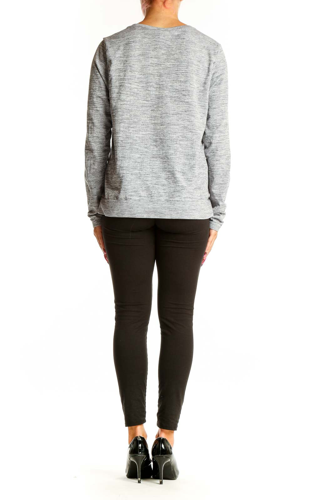 Side view of woman wearing Athleta gray heathered long sleeve top with black pants