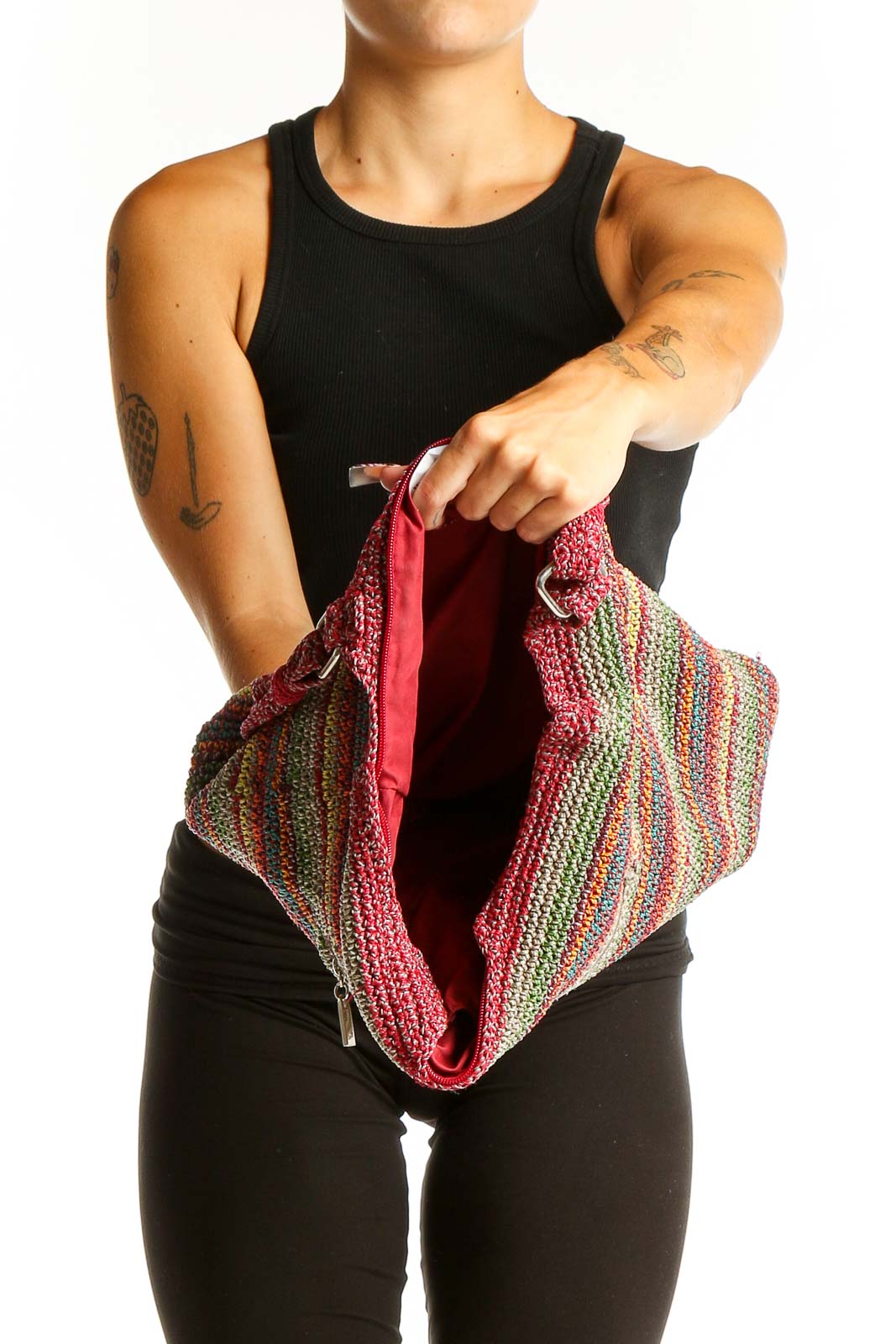 Side view of The Sak multicolor striped crochet shoulder bag worn by model