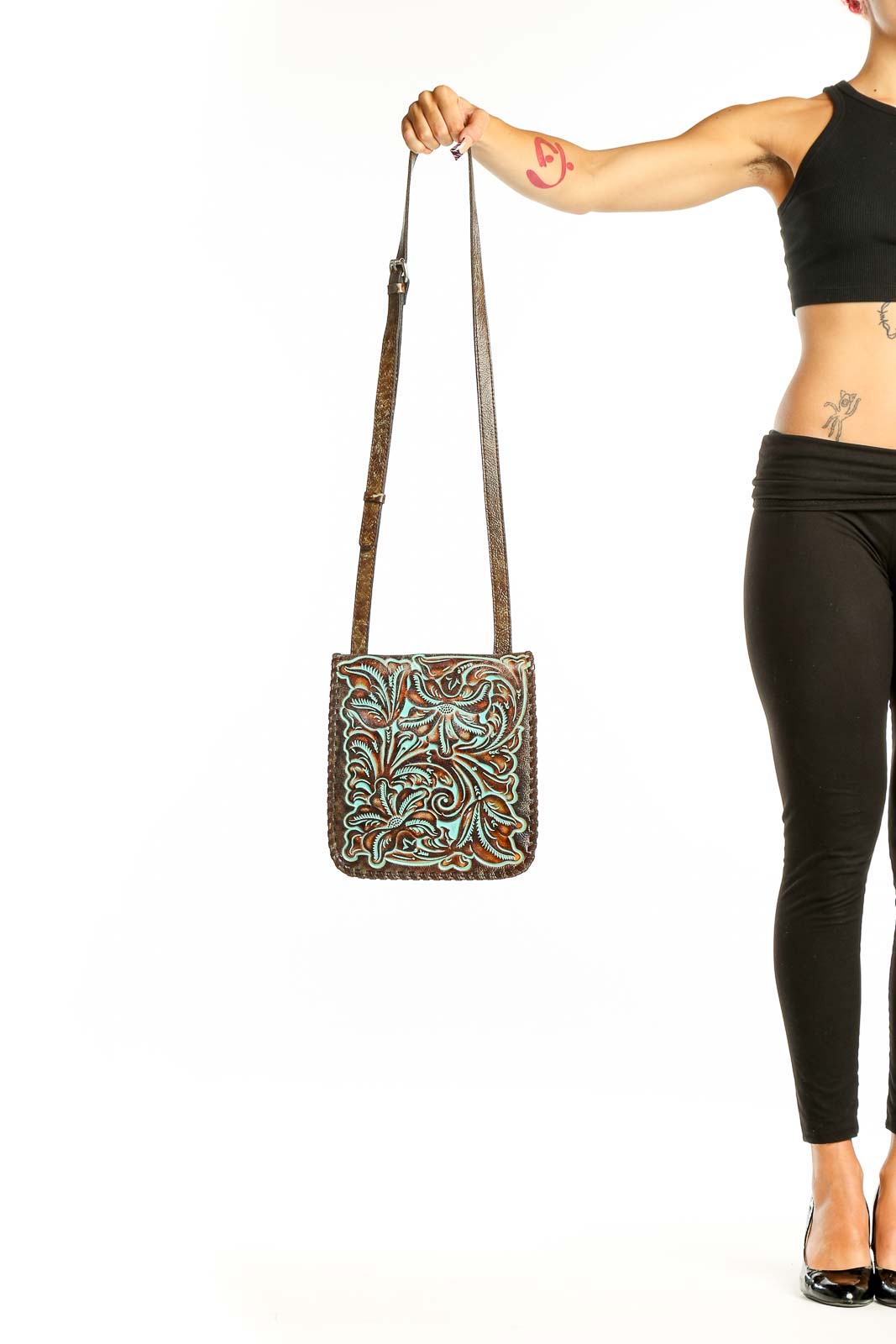 Front view of Patricia Nash brown tooled leather crossbody bag with turquoise floral design