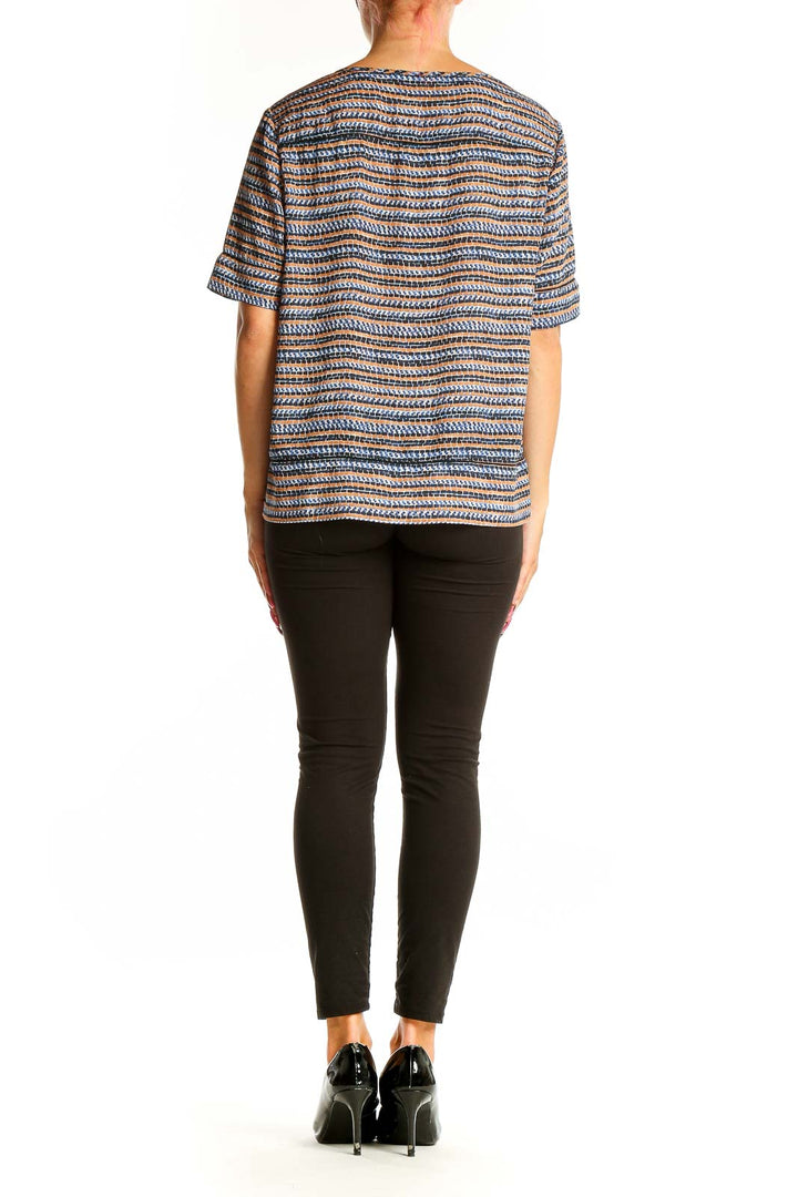 Side view of woman wearing Scotch & Soda blue striped short sleeve top with black pants