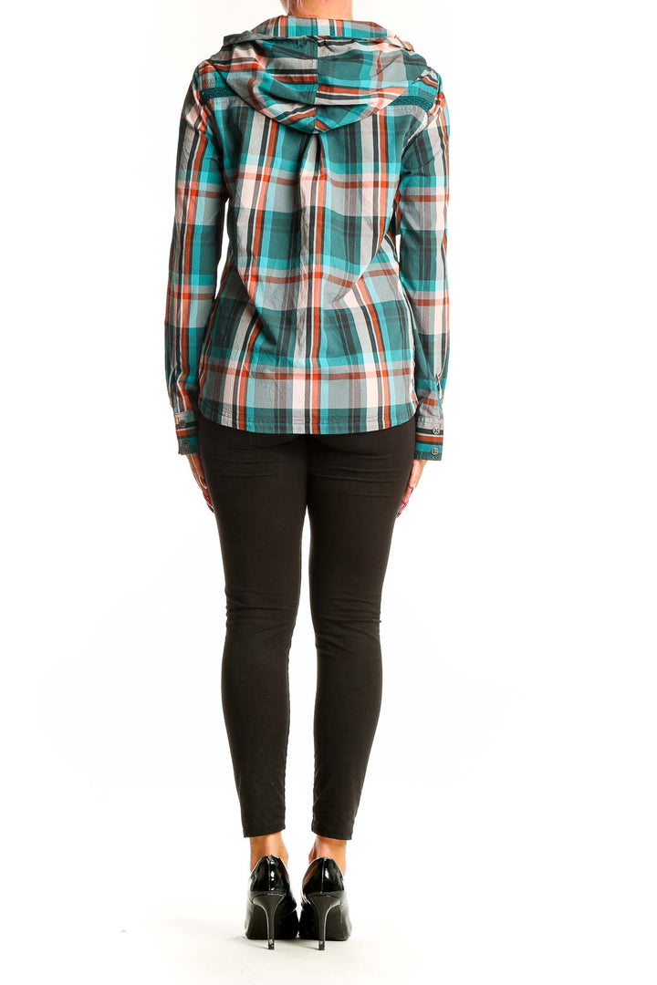 Side view of woman wearing teal plaid hooded button-up shirt from prAna