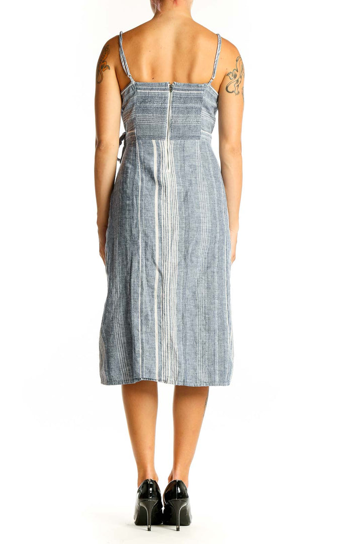 Side view of Express blue striped cotton-linen midi dress showing wrap-style skirt and side slit