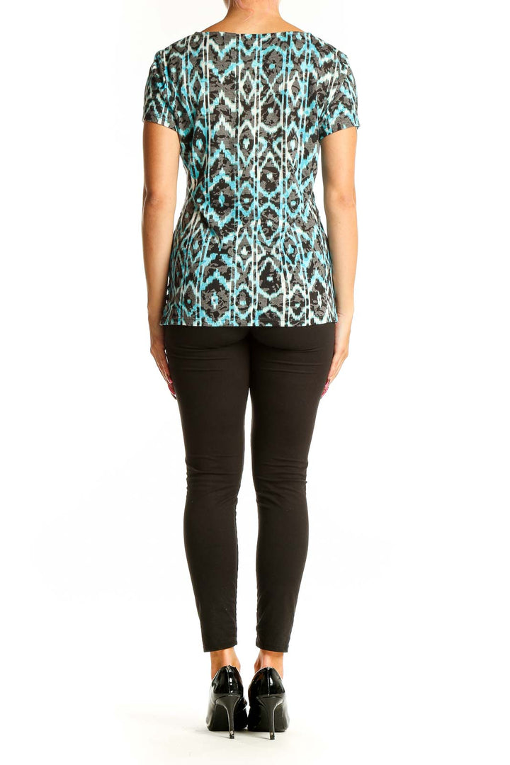 Side view of turquoise ikat print V-neck top with gathered waist by International Concepts